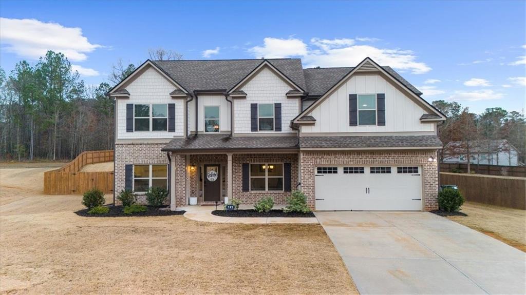 182 Bella Drive Monroe, GA 30655 - Photo 2 of 63 a front view of a house with a yard