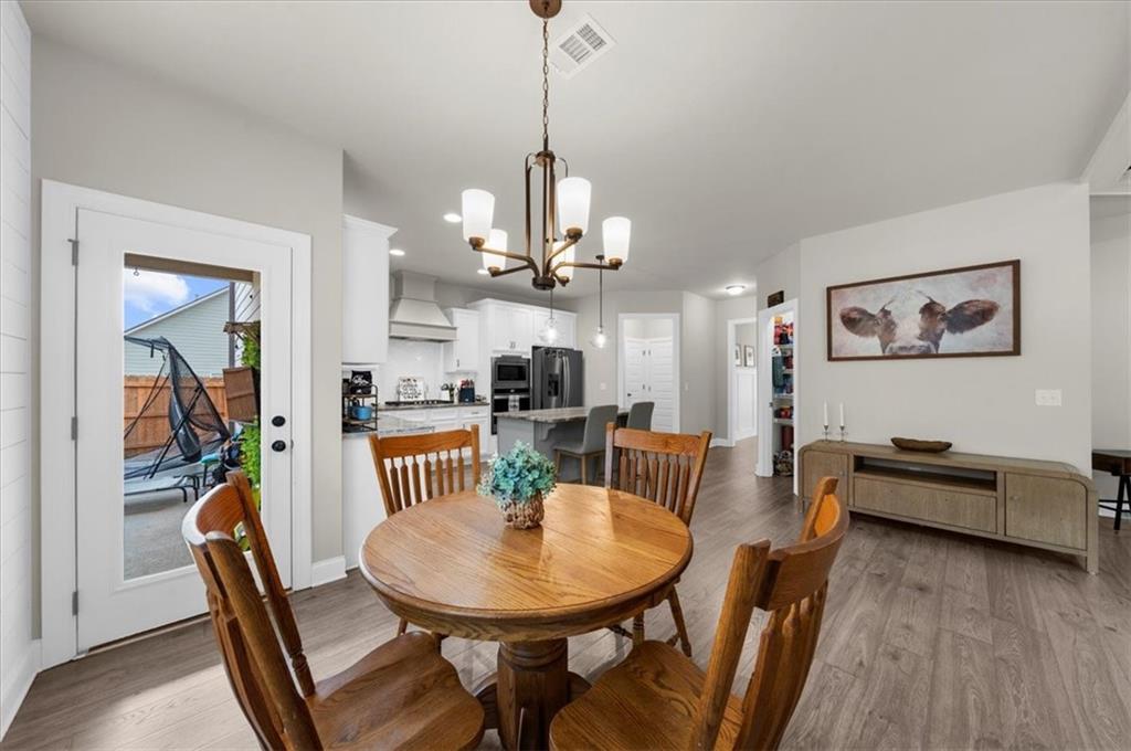 182 Bella Drive Monroe, GA 30655 - Photo 21 of 63 a view of a dining room with furniture and wooden floor
