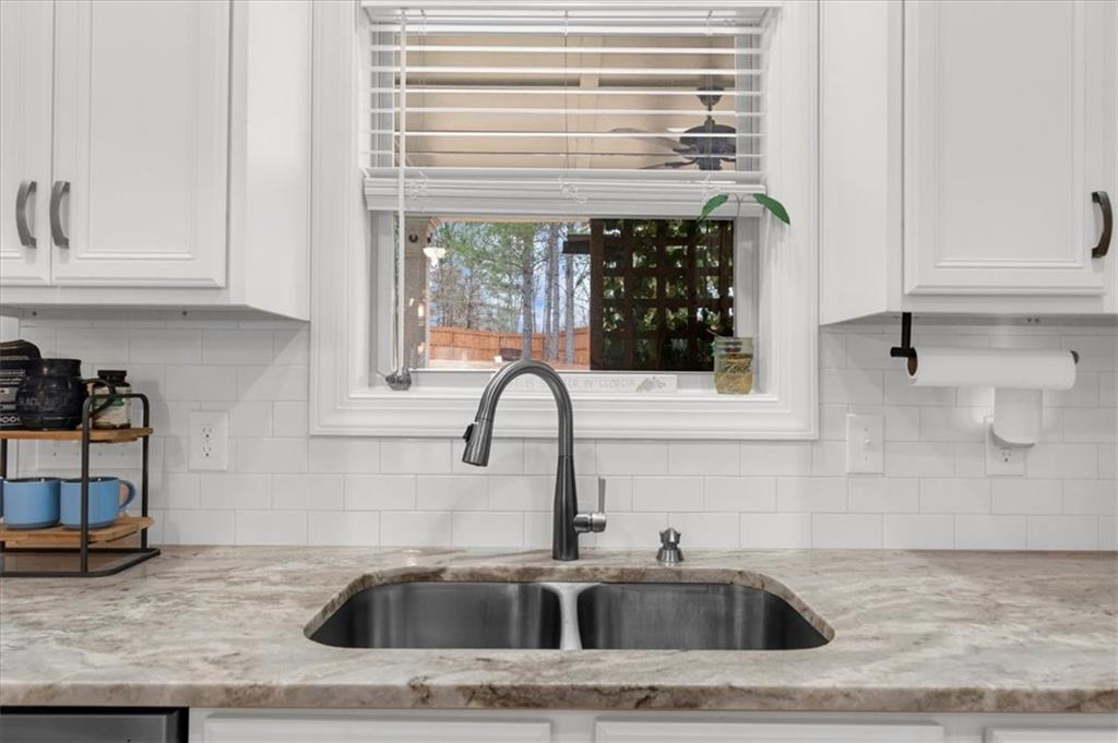 182 Bella Drive Monroe, GA 30655 - Photo 29 of 63 a kitchen with a sink and cabinets
