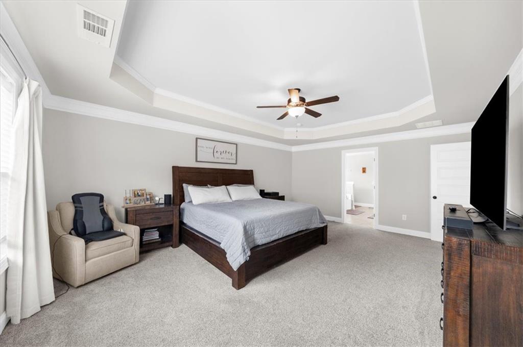 182 Bella Drive Monroe, GA 30655 - Photo 35 of 63 a bedroom with a bed flat screen tv and couches