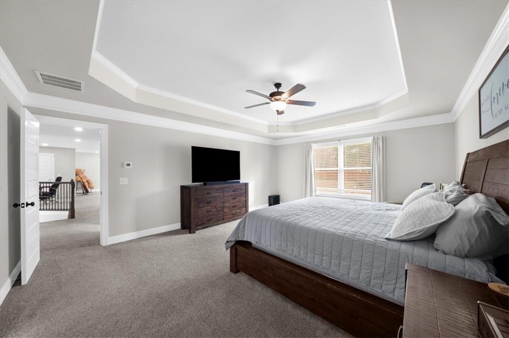 182 Bella Drive Monroe, GA 30655 - Photo 36 of 63 a bedroom with a bed and a flat screen tv