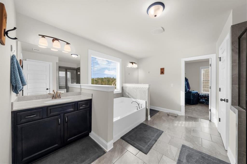 182 Bella Drive Monroe, GA 30655 - Photo 37 of 63 a spacious bathroom with a double vanity sink and mirror