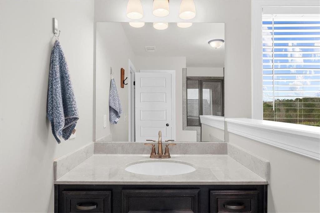 182 Bella Drive Monroe, GA 30655 - Photo 39 of 63 a bathroom with a sink and a mirror