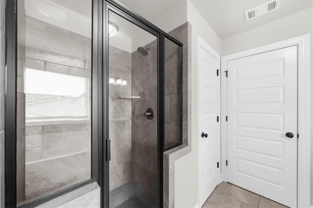 182 Bella Drive Monroe, GA 30655 - Photo 42 of 63 a bathroom with a glass shower door