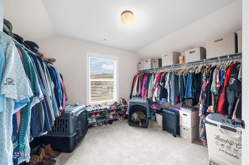 182 Bella Drive Monroe, GA 30655 - Photo 43 of 63 a view of walk in closet with clothes and shoes