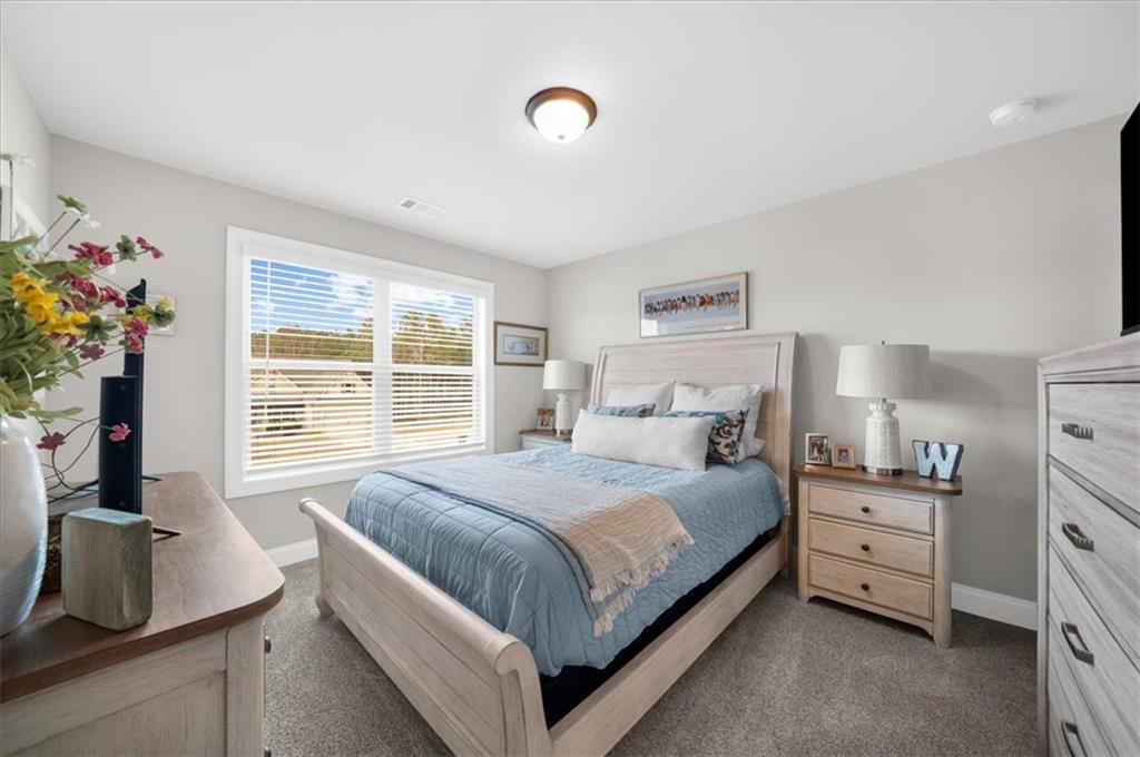 182 Bella Drive Monroe, GA 30655 - Photo 44 of 63 a bedroom with a bed and a dresser