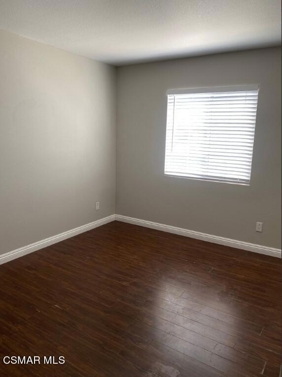 2753 Titania Place Simi Valley, CA 93063 - Photo 12 of 14 an empty room with wooden floor and windows