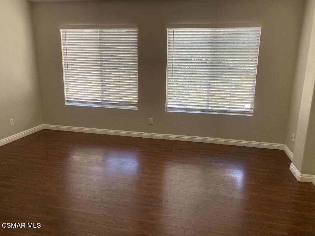 2753 Titania Place Simi Valley, CA 93063 - Photo 9 of 14 a view of an empty room with wooden floor and a window