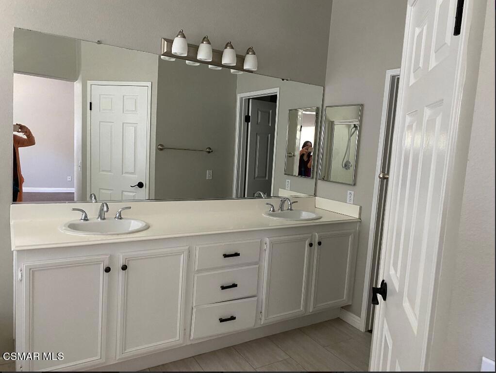 2753 Titania Place Simi Valley, CA 93063 - Photo 10 of 14 a bathroom with a double vanity sink and a mirror