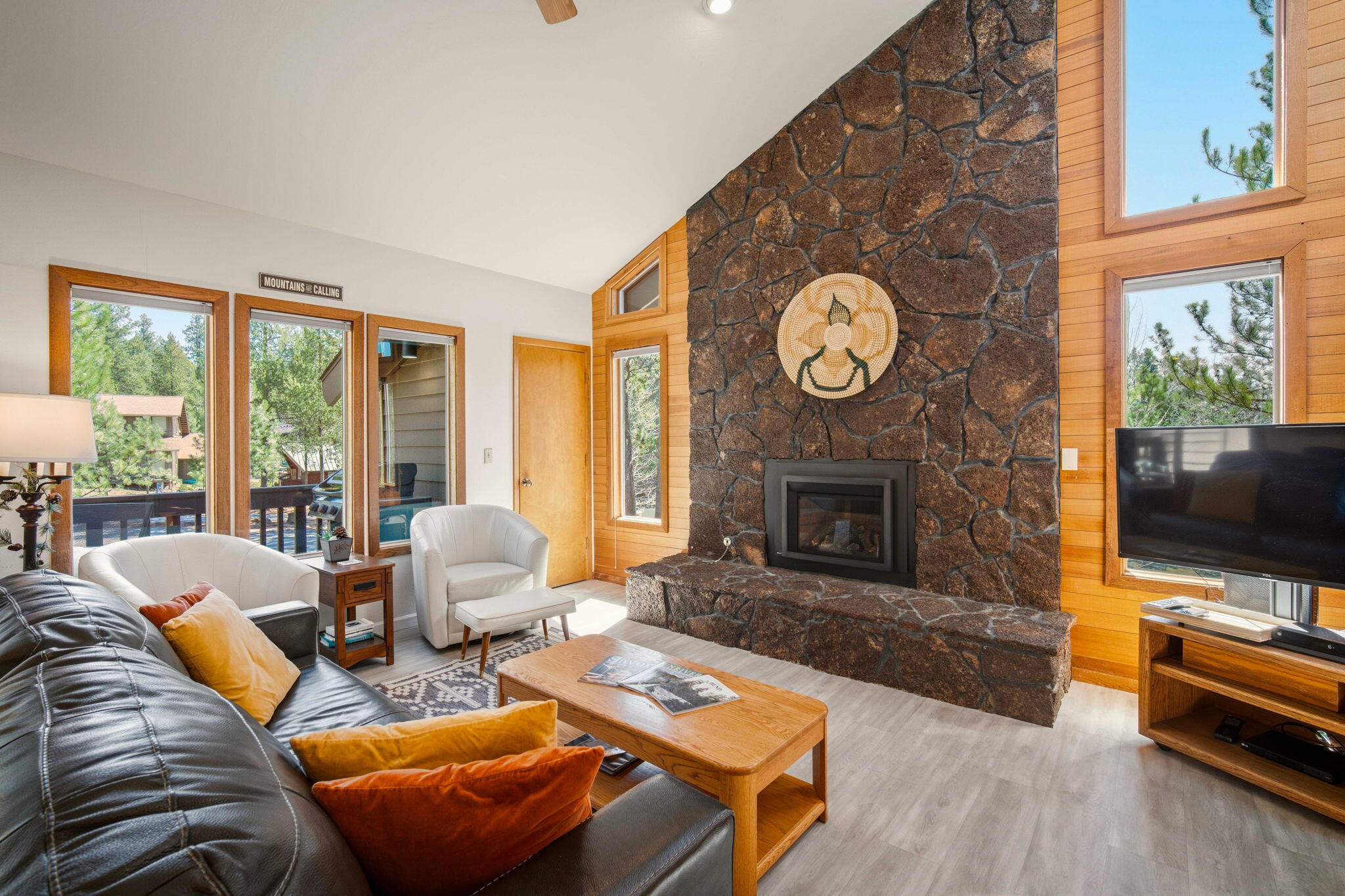 a living room with furniture a fireplace and a flat screen tv