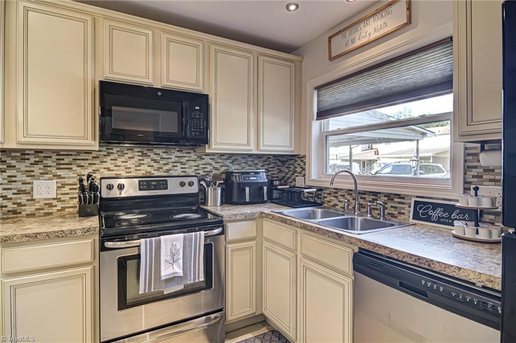 2215 Shadow Valley Road, Unit B High Point, NC 27265 - Photo 14 of 33 This hardworking kitchen features double sink, tons of cabinets, lots of counterspace, tile backsplash, and recessed lights!