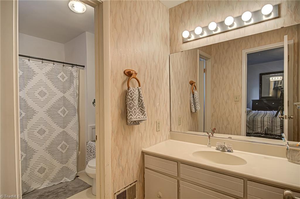 2215 Shadow Valley Road, Unit B High Point, NC 27265 - Photo 22 of 33 Primary bedroom features en suite full bath and vanity area - makes mornings a breeze!