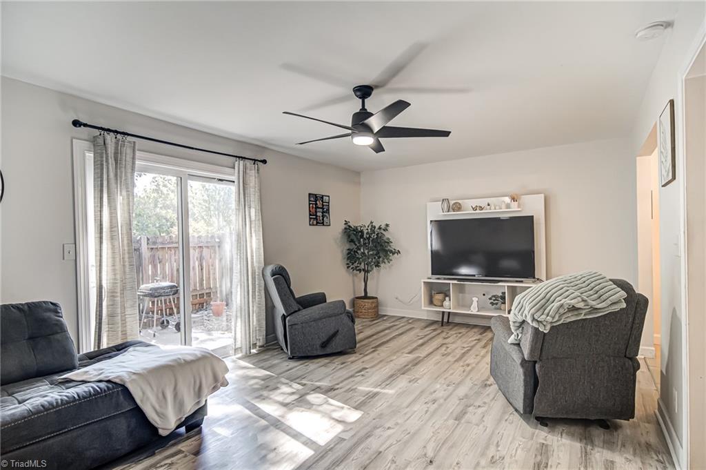 2215 Shadow Valley Road, Unit B High Point, NC 27265 - Photo 5 of 33 Good size living room has ceiling fan, luxury vinyl plank flooring, and sliding doors that open to rear patio.