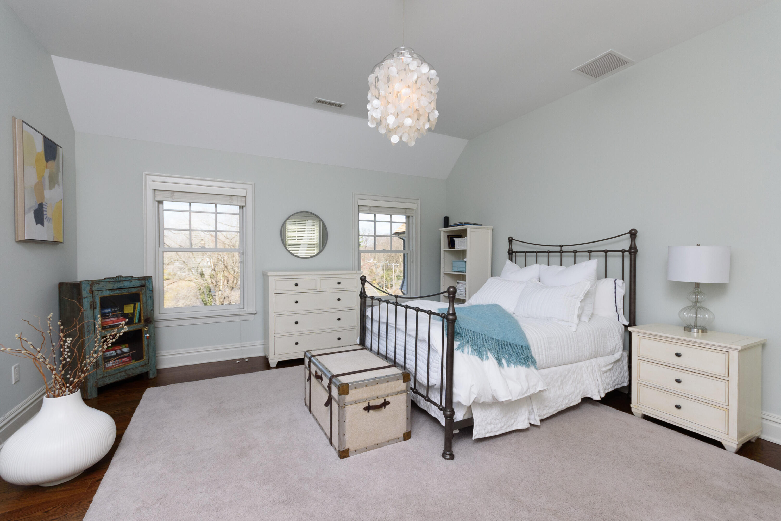 80 Goodwives River Road Darien, CT 06820 - Photo 31 of 57 a spacious bedroom with a bed a chandelier and dresser