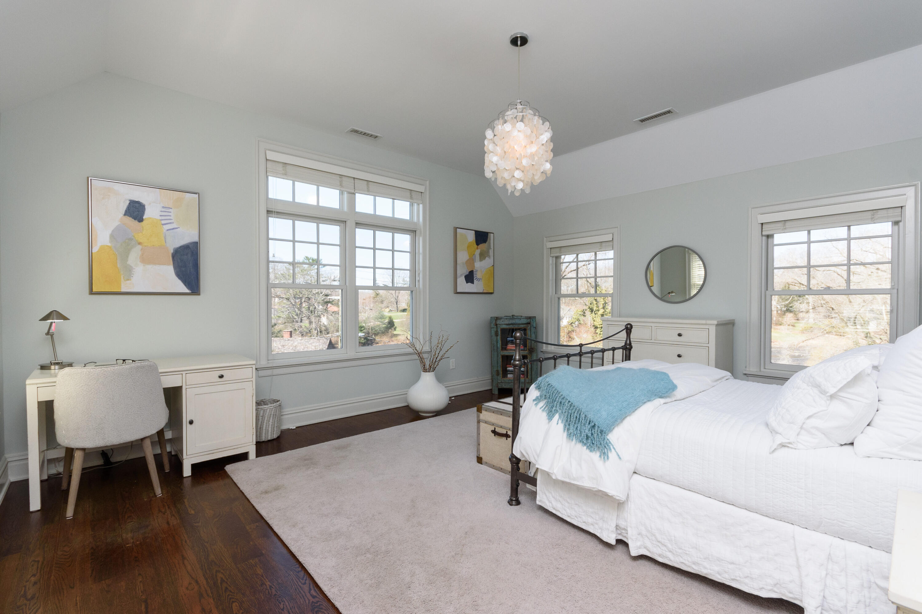 80 Goodwives River Road Darien, CT 06820 - Photo 32 of 57 a spacious bedroom with a bed table chair and a window