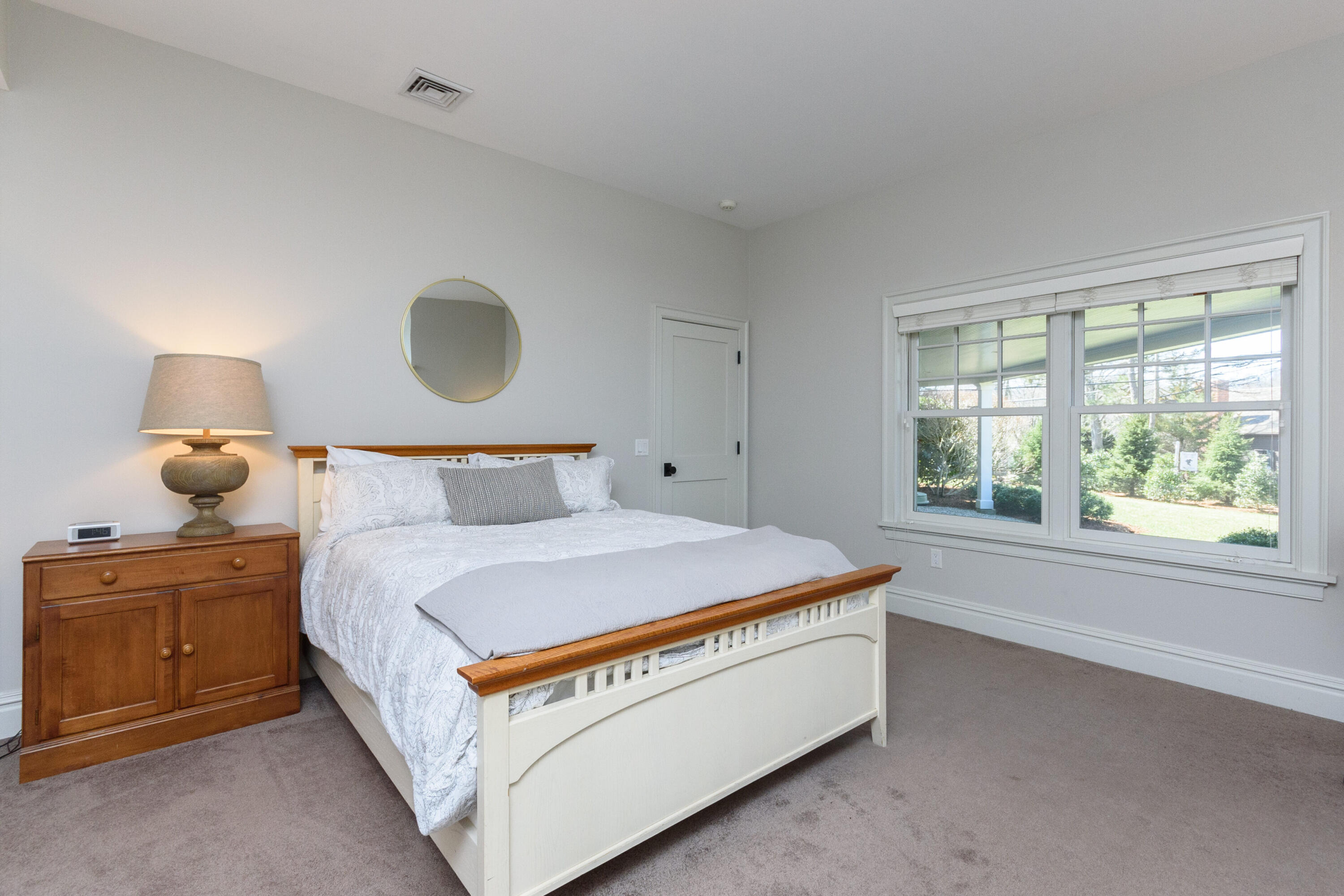 80 Goodwives River Road Darien, CT 06820 - Photo 45 of 57 a bed sitting in a bedroom next to a window