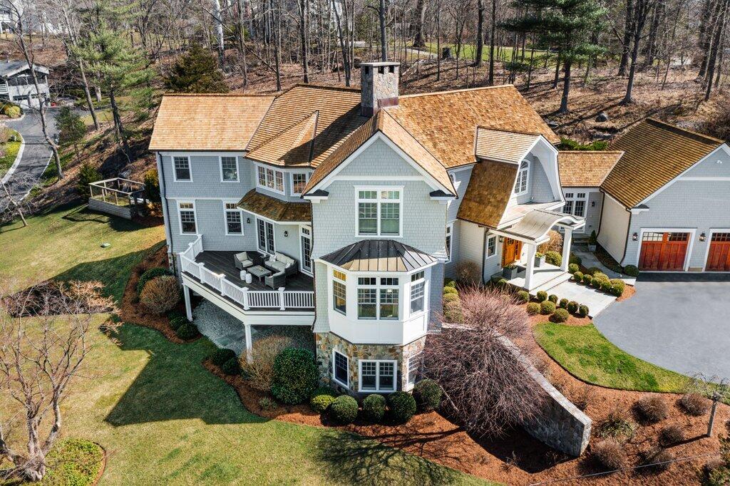 80 Goodwives River Road Darien, CT 06820 - Photo 5 of 57 a front view of a house with a garden and lake view