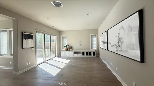 a living room with furniture and large windows