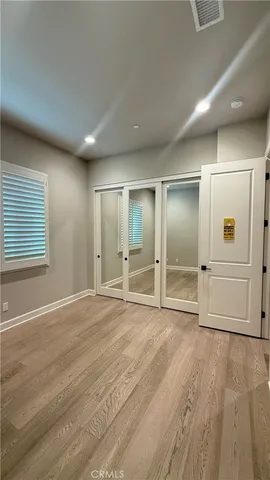 a view of an empty room with wooden cabinet