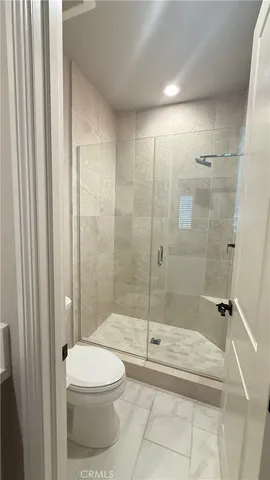 a bathroom with a toilet and shower