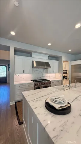 a kitchen with a sink a stove and cabinets