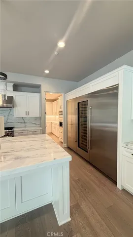 a view of kitchen with refrigerator and window