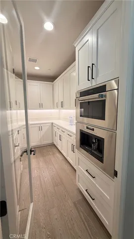 a kitchen with a stove oven and white cabinets
