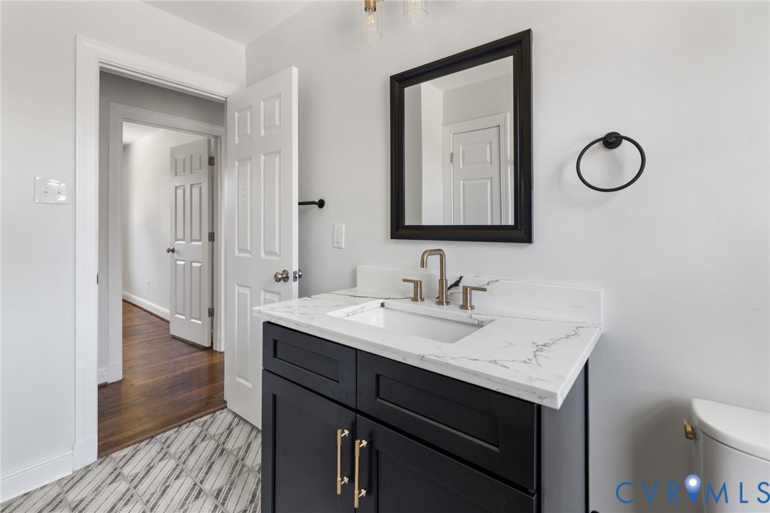 2002 Milbank Road Henrico, VA 23229 - Photo 13 of 23 a bathroom with a sink and a mirror