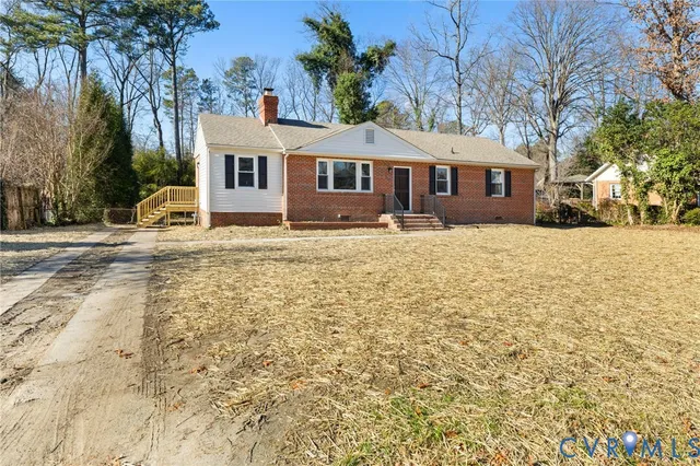 a front view of a house with a yard covered in snow