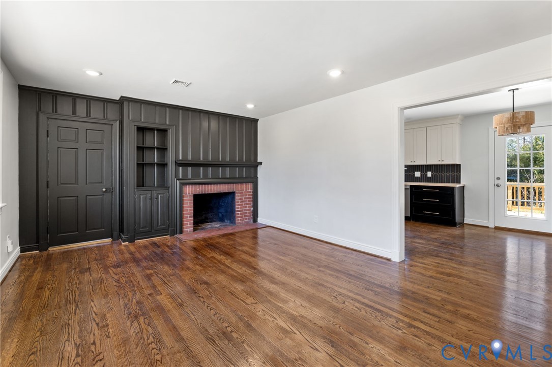 2002 Milbank Road Henrico, VA 23229 - Photo 3 of 23 a view of empty room with wooden floor and fireplace