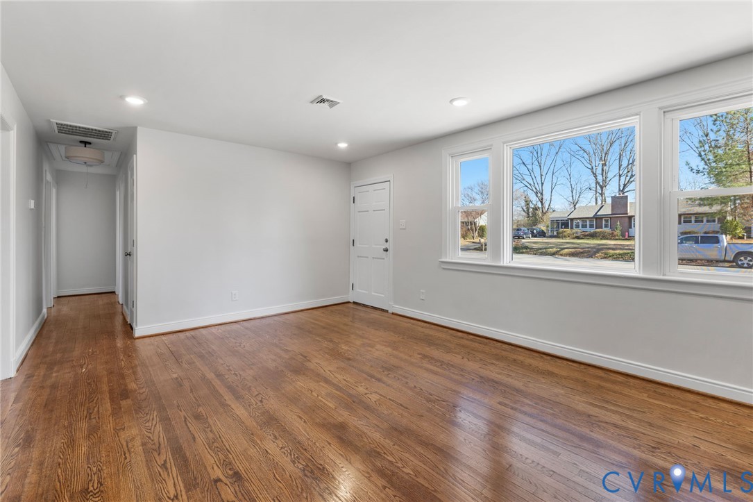 2002 Milbank Road Henrico, VA 23229 - Photo 4 of 23 a view of an empty room with wooden floor and a window