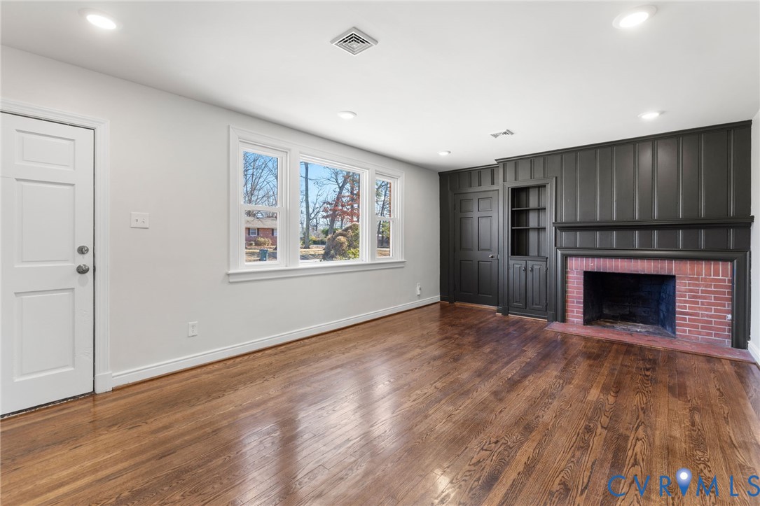 2002 Milbank Road Henrico, VA 23229 - Photo 5 of 23 a view of empty room with wooden floor and fireplace
