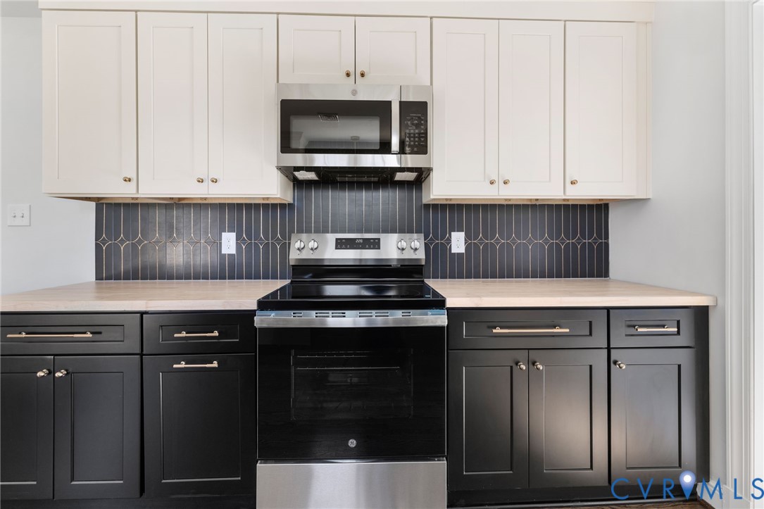 2002 Milbank Road Henrico, VA 23229 - Photo 10 of 23 a kitchen with granite countertop a stove top oven and cabinets