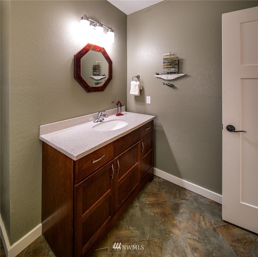 710 Fieldston Road Bellingham, WA 98225 - Photo 16 of 27 a bathroom with a sink and a mirror