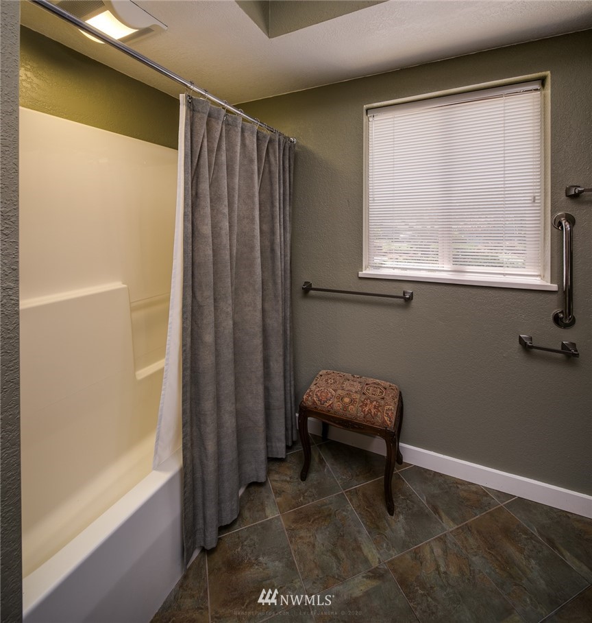 710 Fieldston Road Bellingham, WA 98225 - Photo 17 of 27 a bathroom with a window and a chair