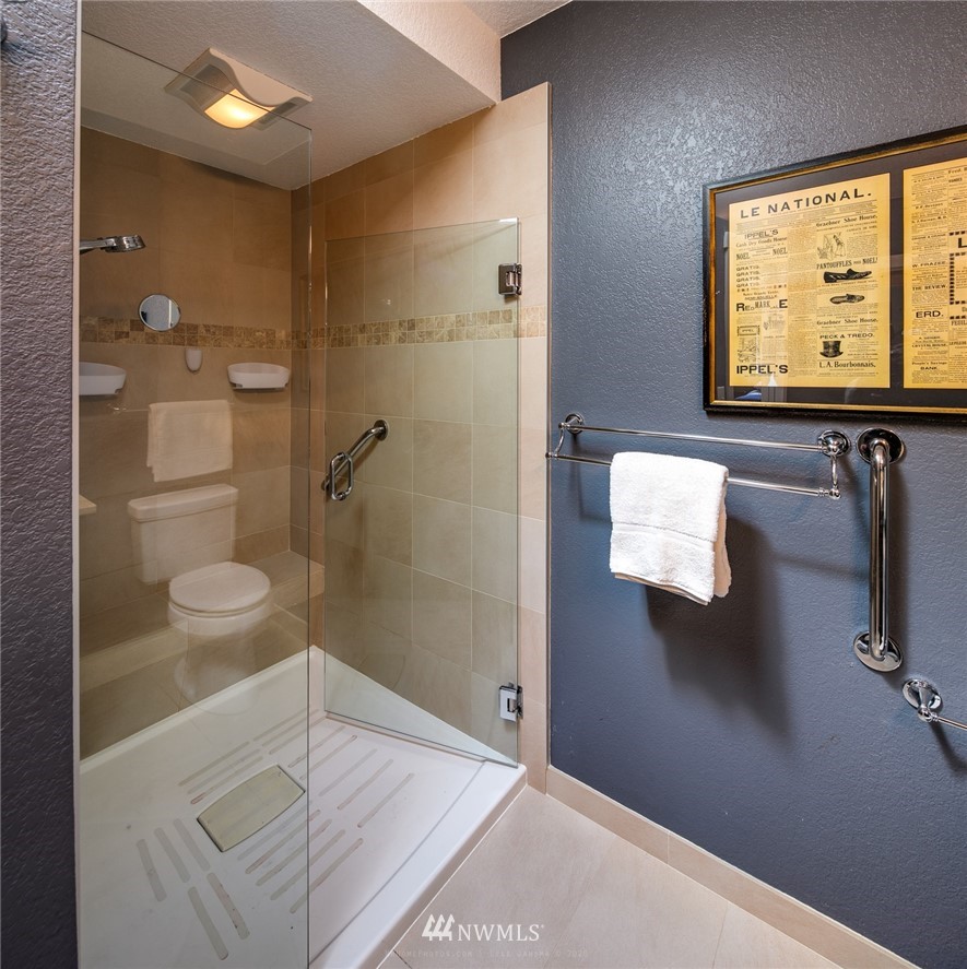 710 Fieldston Road Bellingham, WA 98225 - Photo 23 of 27 a bathroom with a granite countertop sink a toilet and shower