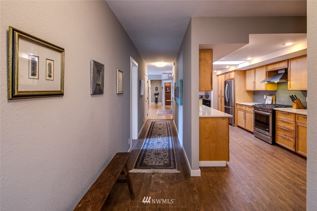 710 Fieldston Road Bellingham, WA 98225 - Photo 5 of 27 a living room with stainless steel appliances furniture a large window and a wooden floor