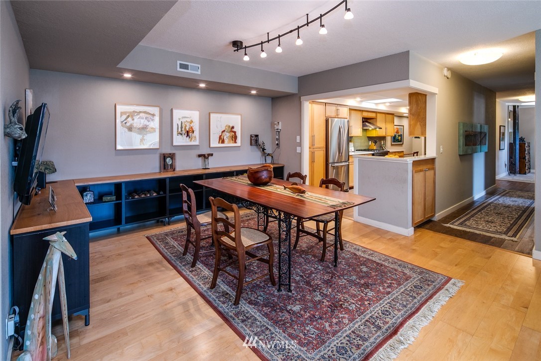 710 Fieldston Road Bellingham, WA 98225 - Photo 10 of 27 a living room with dining table a rug and kitchen view