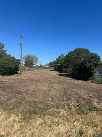 a view of a field with an ocean view