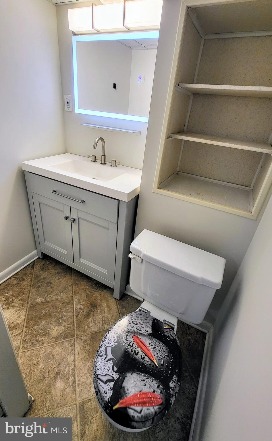 3339 Acton Road Parkville, MD 21234 - Photo 33 of 37 a bathroom with a toilet sink and vanity