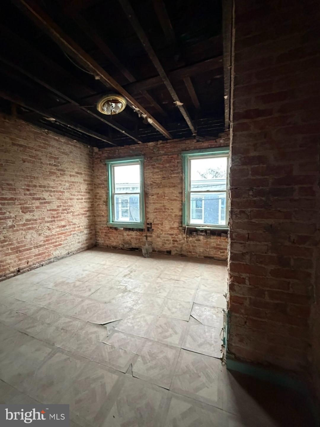 1608 Lemmon Street Baltimore, MD 21223 - Photo 9 of 21 a view of an empty room with windows