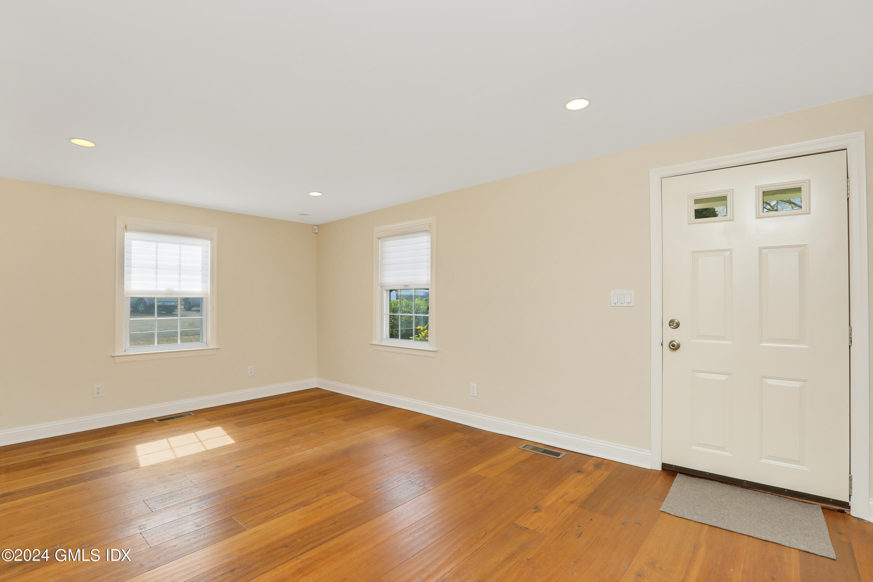 13 Riverside Lane Riverside, CT 06878 - Photo 11 of 25 an empty room with wooden floor and windows
