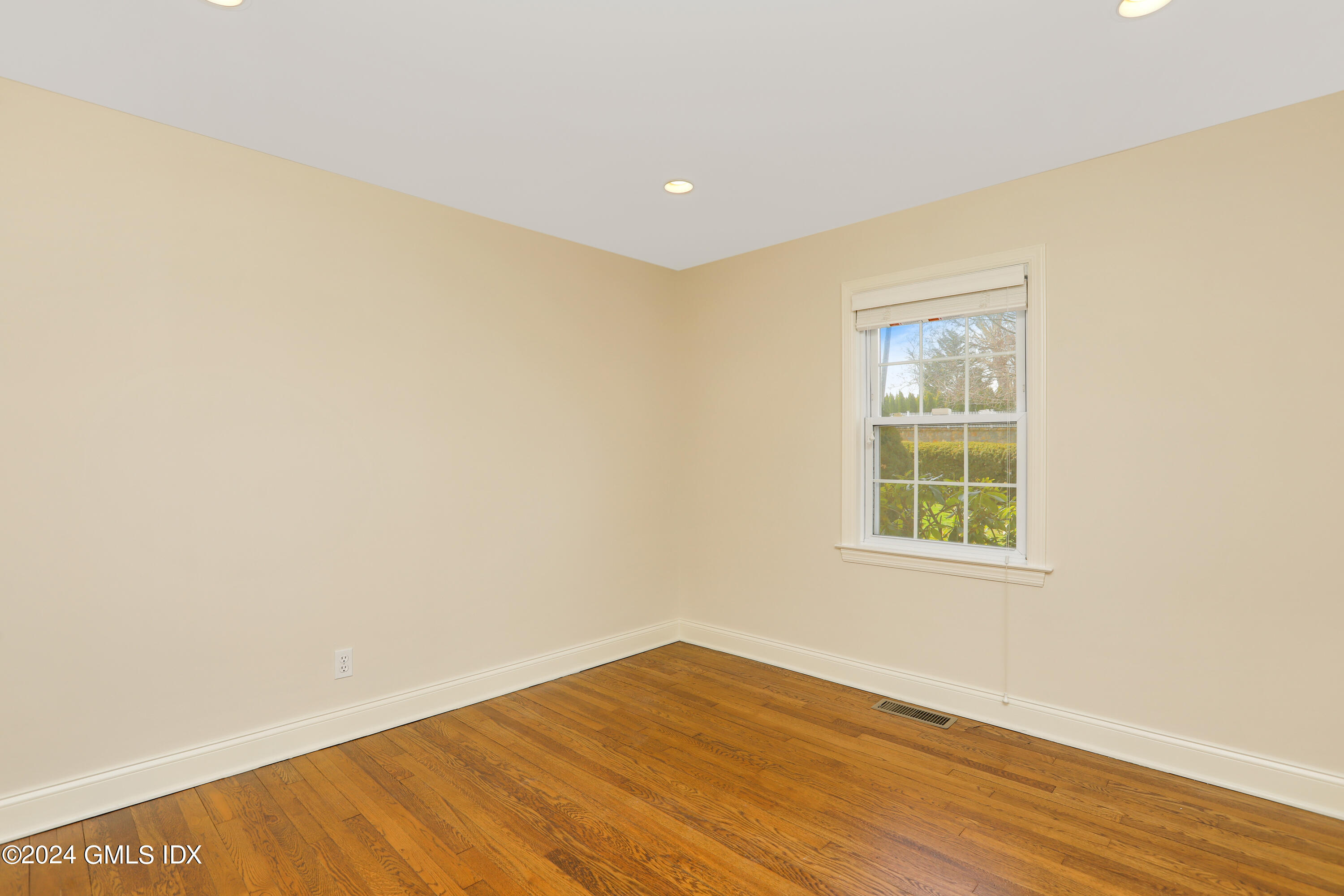 13 Riverside Lane Riverside, CT 06878 - Photo 13 of 25 an empty room with wooden floor and windows