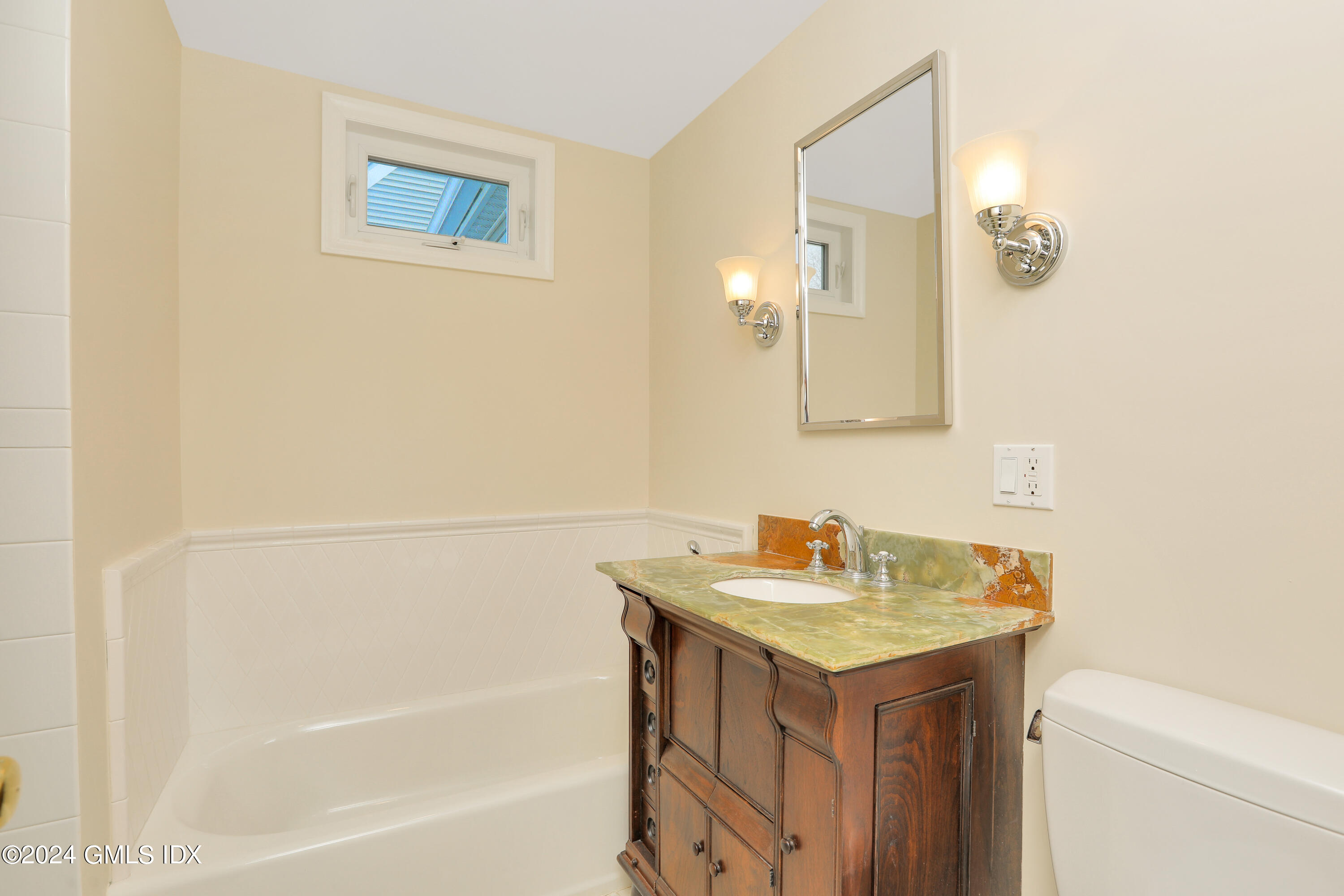 13 Riverside Lane Riverside, CT 06878 - Photo 15 of 25 a bathroom with a sink and a mirror