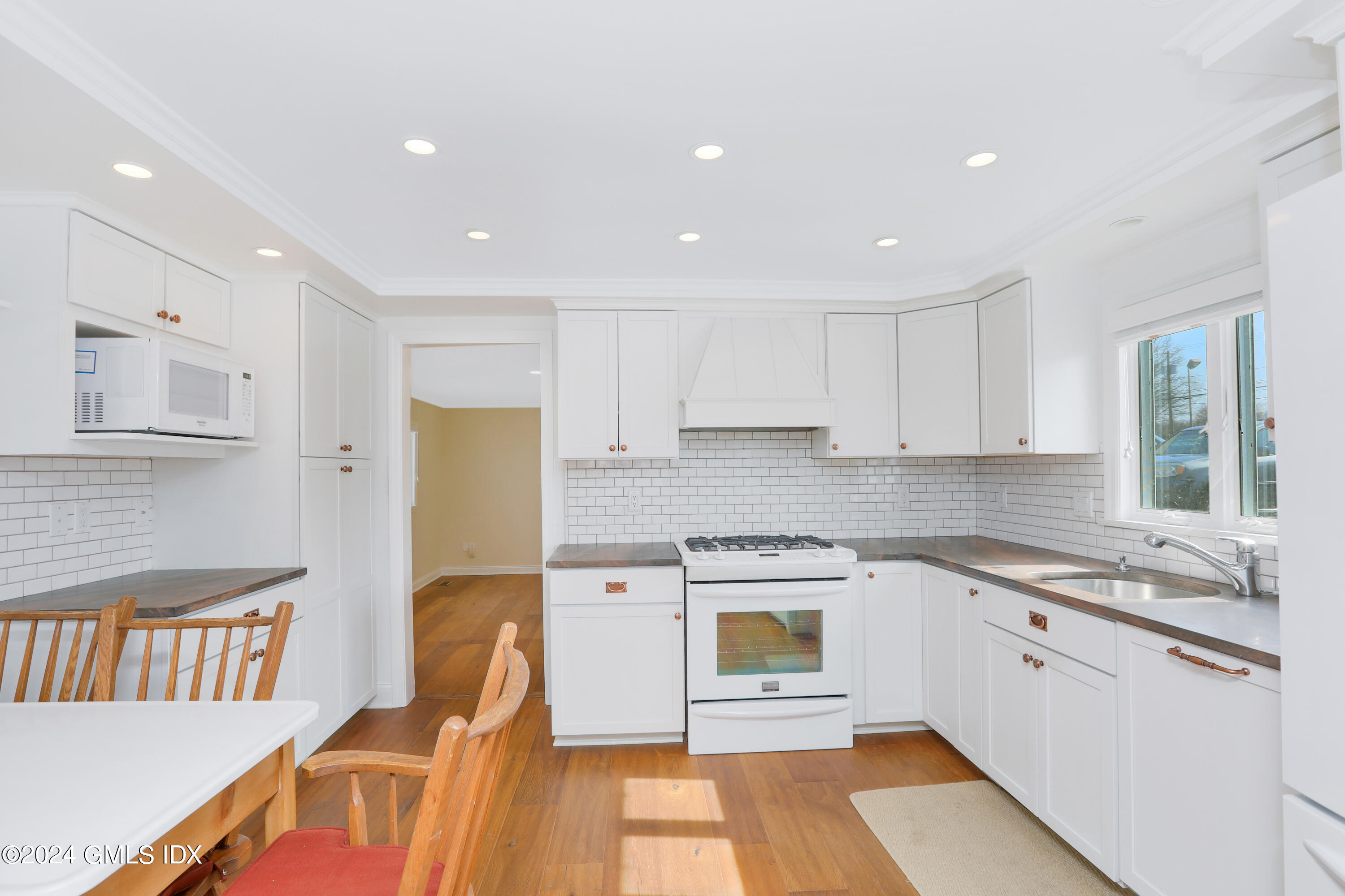 13 Riverside Lane Riverside, CT 06878 - Photo 4 of 25 a kitchen with stainless steel appliances granite countertop a sink and a stove