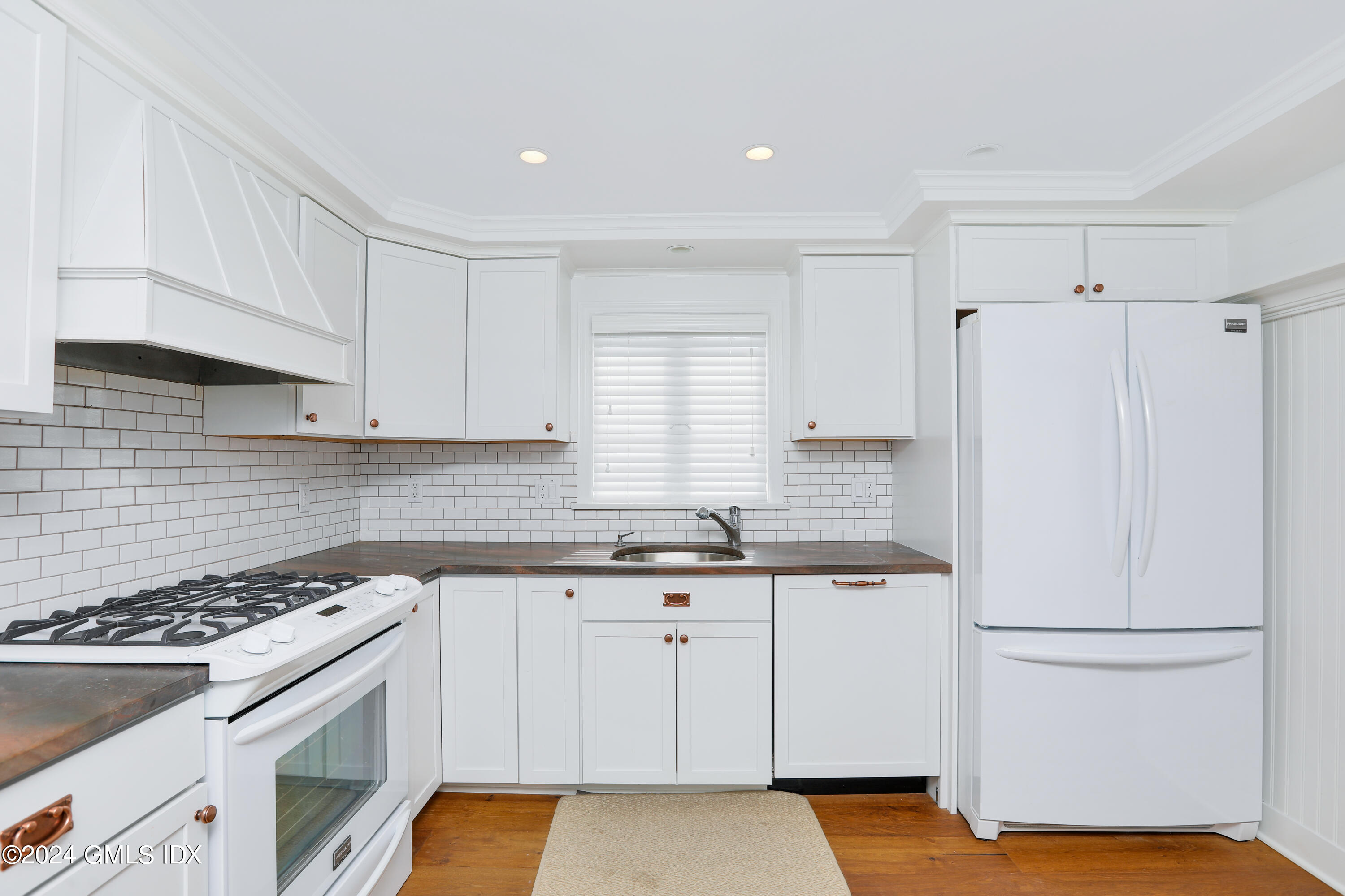 13 Riverside Lane Riverside, CT 06878 - Photo 5 of 25 a kitchen with a white cabinets and white appliances