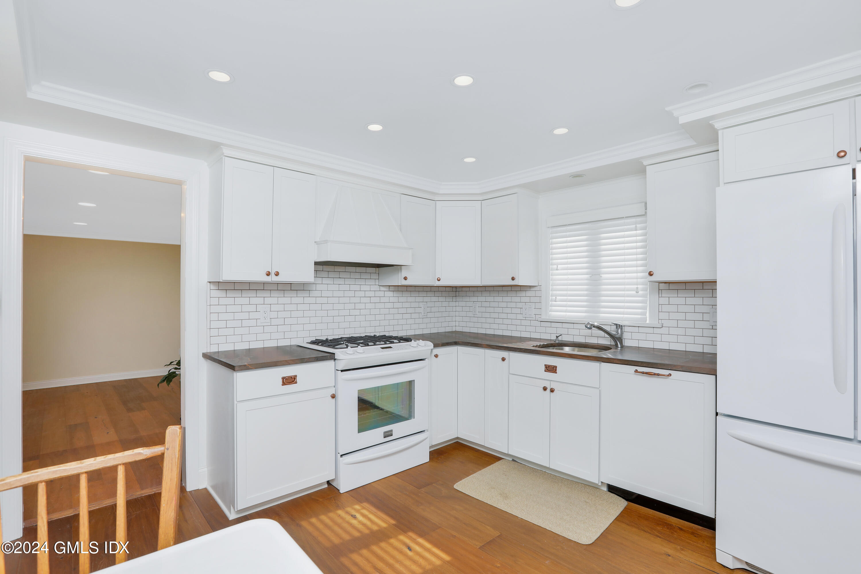 13 Riverside Lane Riverside, CT 06878 - Photo 6 of 25 a kitchen with granite countertop white cabinets and white appliances