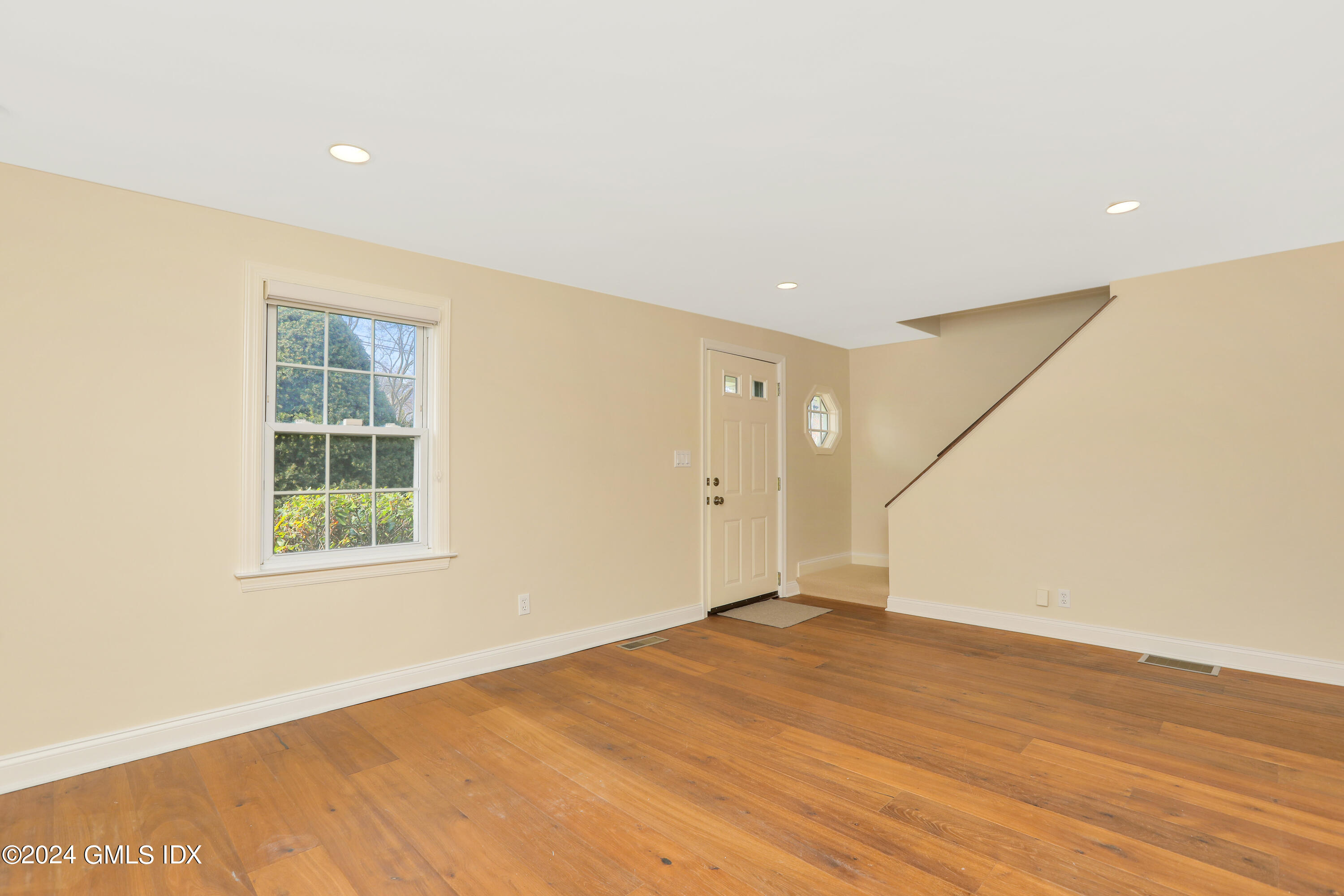 13 Riverside Lane Riverside, CT 06878 - Photo 10 of 25 an empty room with wooden floor and windows