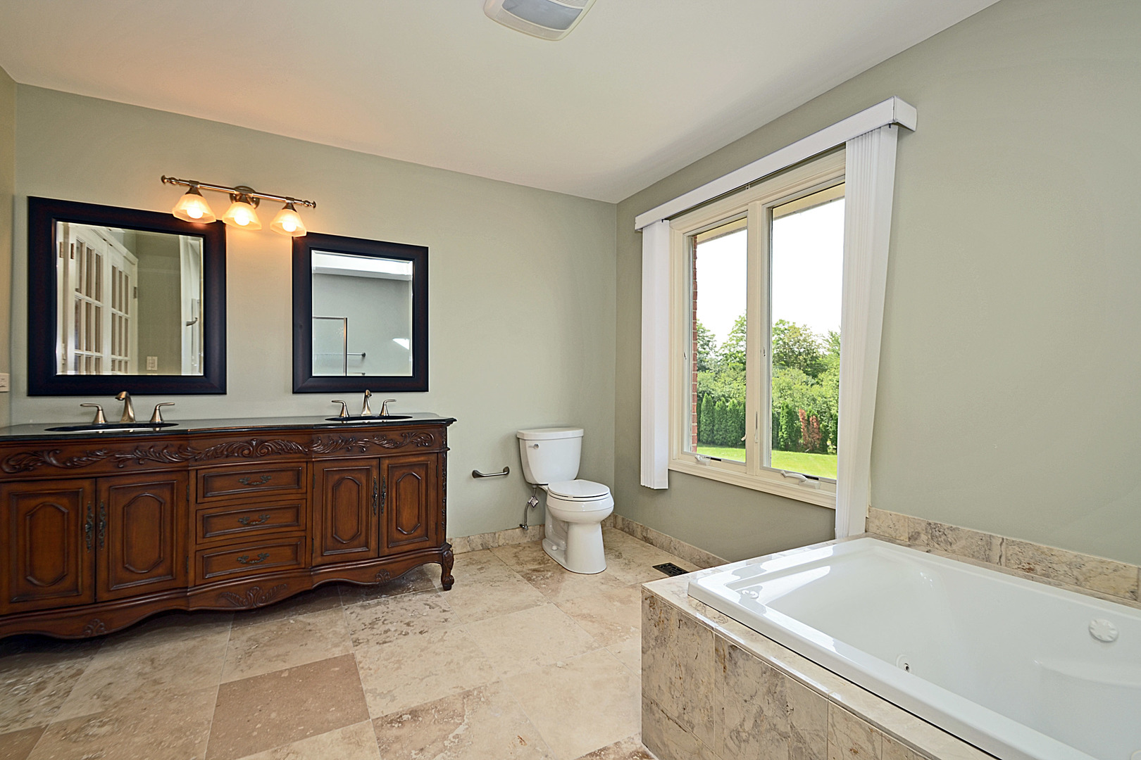 1435 Dunheath Drive Inverness, IL 60010 - Photo 13 of 27 a spacious bathroom with a granite countertop sink and a large mirror