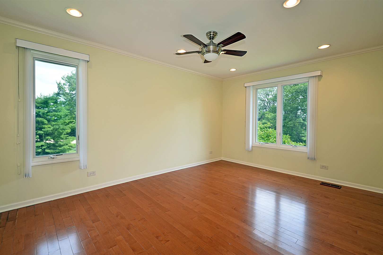 1435 Dunheath Drive Inverness, IL 60010 - Photo 15 of 27 a view of a big room with wooden floor and windows